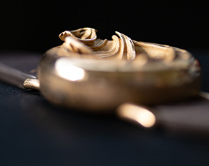 UnconstrainedTime Fractal Emergence 41mm in bronze, on a dark background, shallow depth of field.
